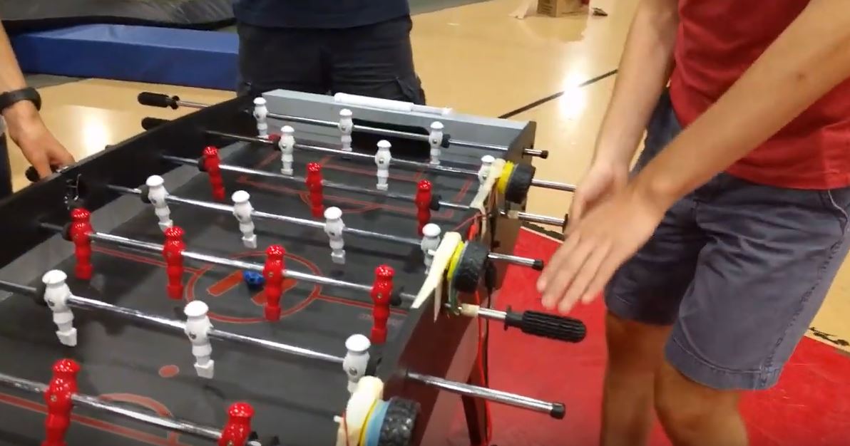 Markus playing foosball on a table rigged with motors and sensors